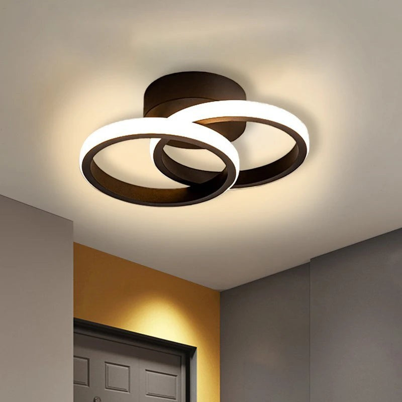 Novoora modern black circular LED ceiling light with dual rings, providing warm ambient lighting for home interiors.