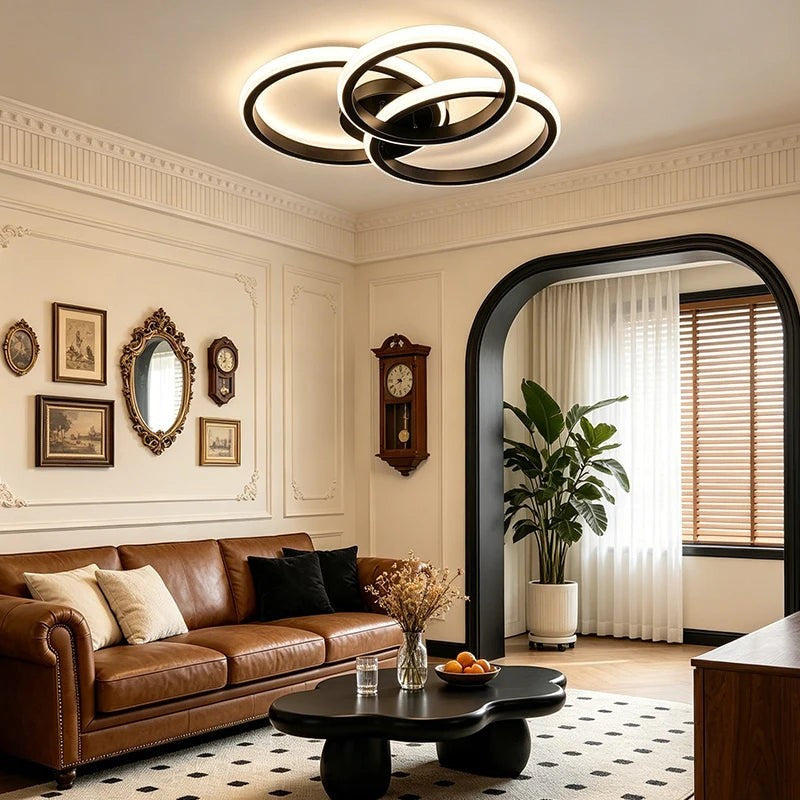 Novoora modern LED ceiling light with interlocking circular rings in a stylish living room with brown leather sofa.