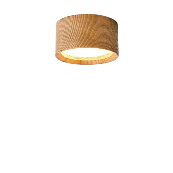 Novoora modern round LED ceiling light with a natural wood finish, casting a warm glow on a white wall.
