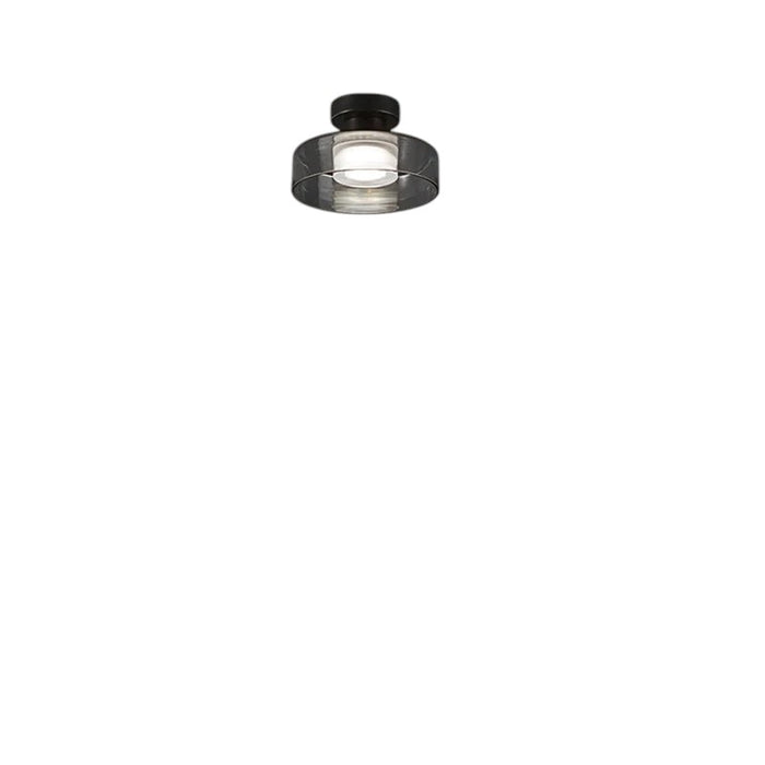Novoora smoked glass LED ceiling light with a black iron base, installed in a modern minimalist hallway.