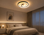 Novoora modern spiral LED ceiling light in black and white, illuminating a cozy minimalist bedroom interior.